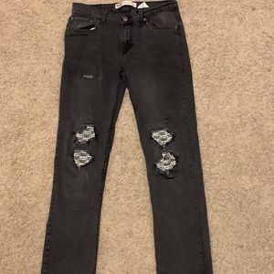 Levi’s ripped jeans with patched knees.